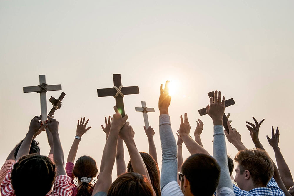 prople holding a cross
